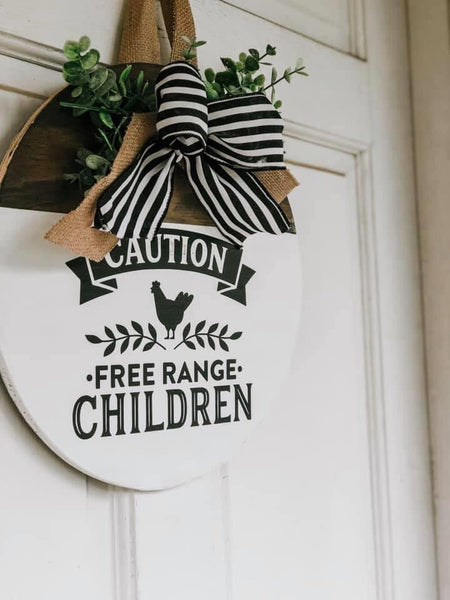 Free range children round sign